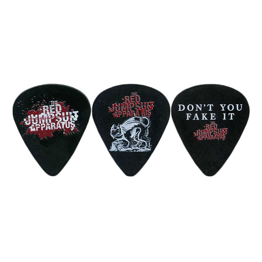 Set of three black guitar picks by The Red Jumpsuit Apparatus: one with the band’s name, one with a wolf illustration plus the band’s name, and one with “DON’T YOU FAKE IT” and the band’s name below.