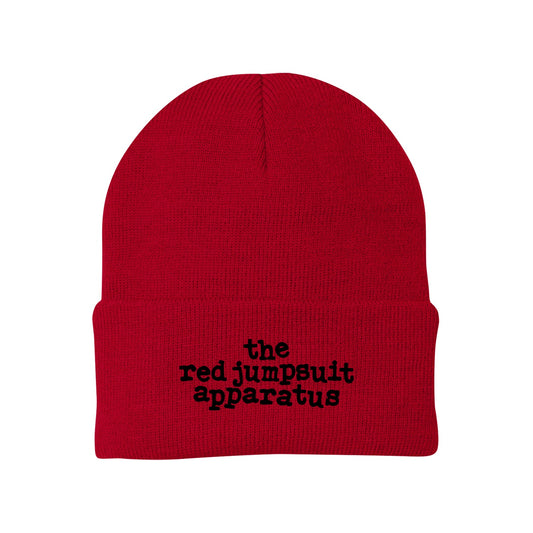 image of a red winter beanie on a white background. front cuff has black embroidered text that says the red jumpsuit apparatus